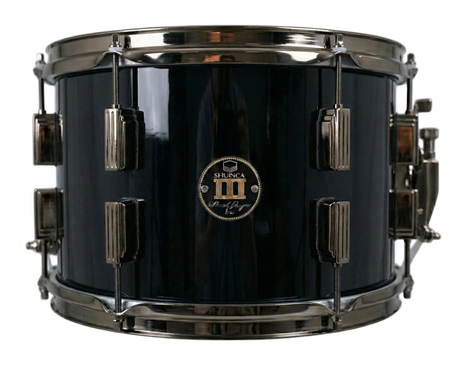 Black snare drum with chrome hardware on a white background